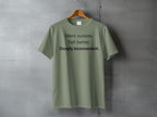 Olive green t-shirt with "Went outside. Felt better. Deeply inconvenient." printed on it.