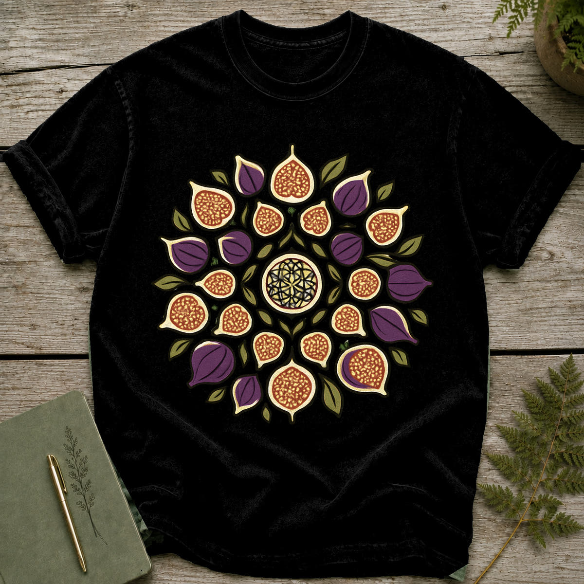 Black t-shirt with a mandala design of figs and leaves.