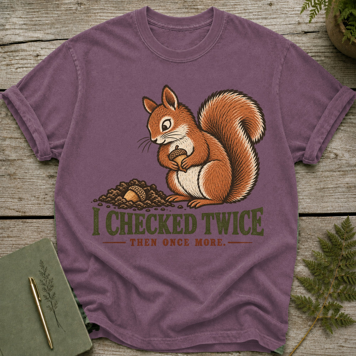 Purple t-shirt with a squirrel holding an acorn and text "I CHECKED TWICE THEN ONCE MORE."