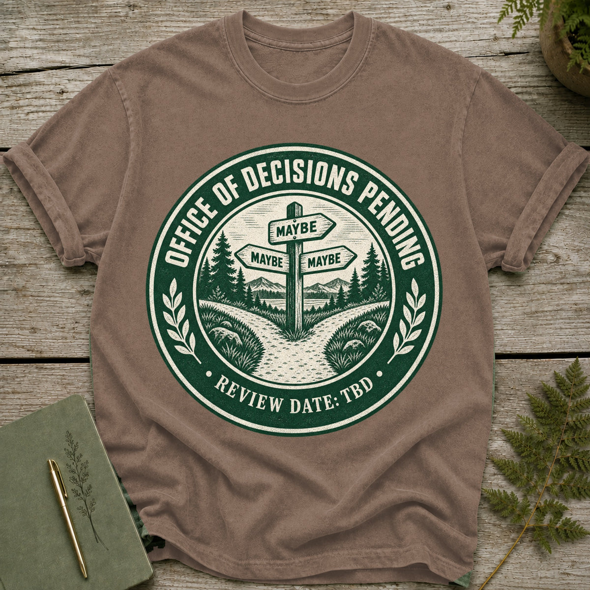 T-shirt with "Office of Decisions Pending" seal and "Review Date: TBD" text.