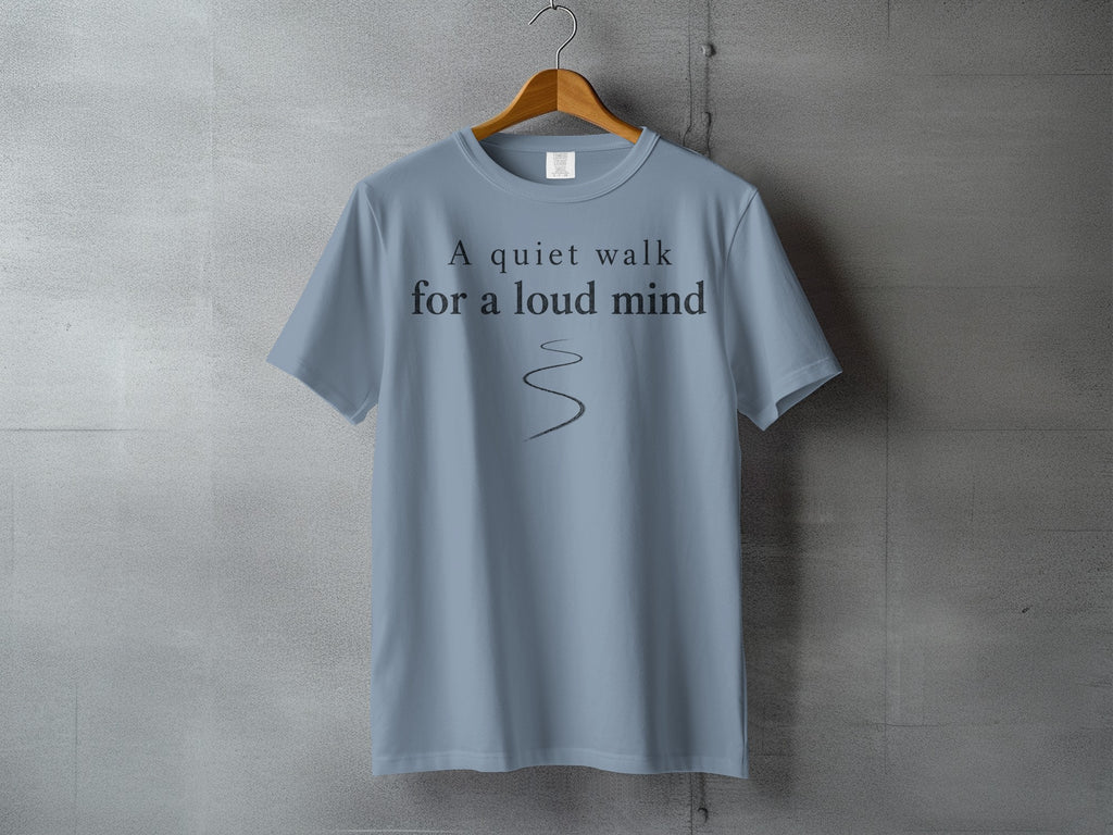 Light blue t-shirt with "A quiet walk for a loud mind" text and winding path graphic.