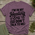 Purple t-shirt with black text: "I'm In My Healing Era (So Don't Talk To Me)"