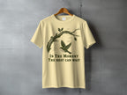 Light yellow t-shirt with a bird on a branch and the text "In The Moment The Rest Can Wait".