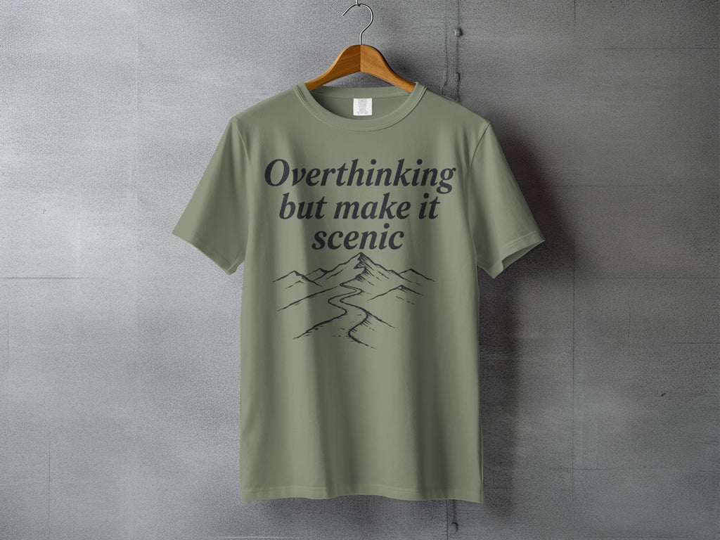 T-shirt with "Overthinking but make it scenic" text and mountain landscape graphic.