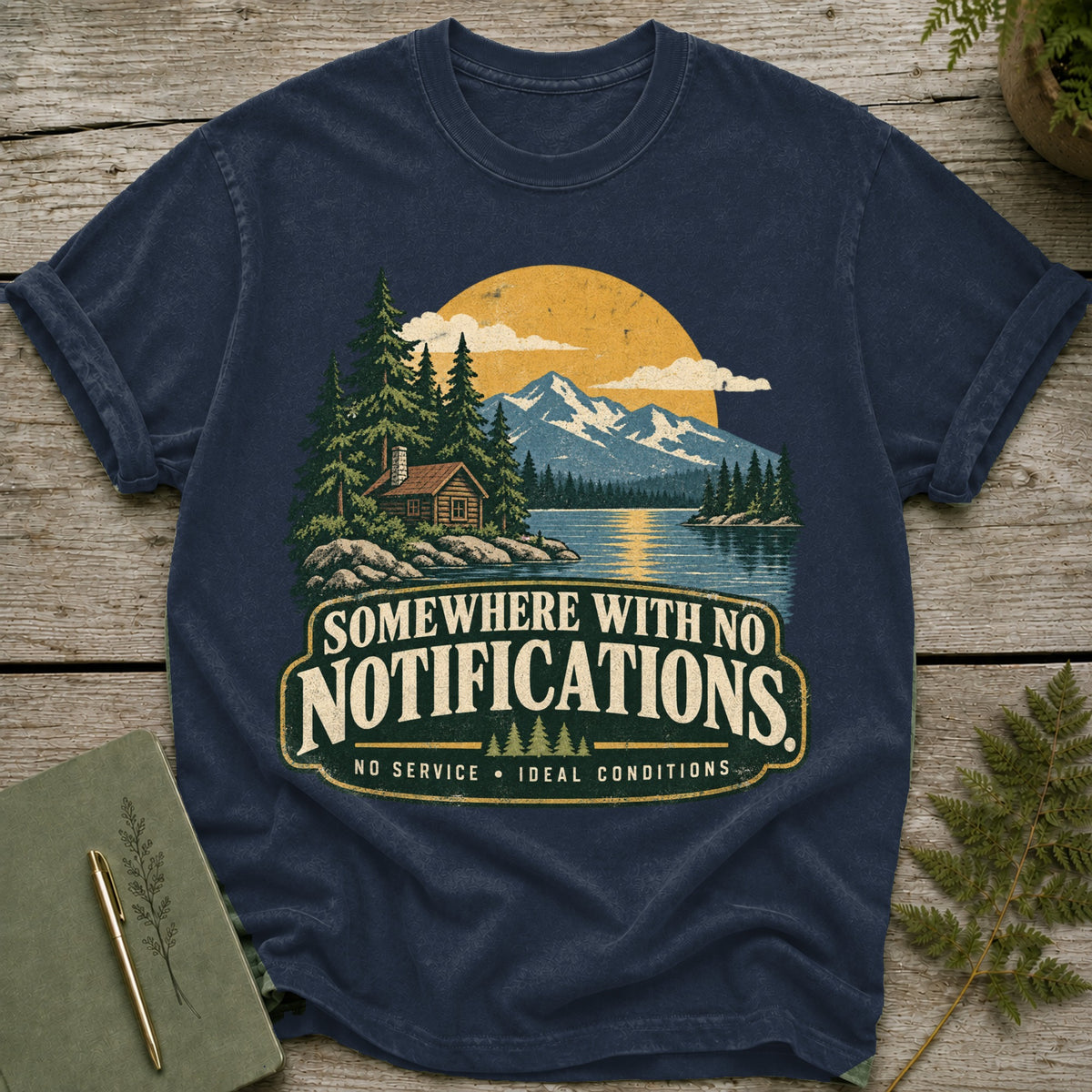Navy t-shirt with "Somewhere With No Notifications" text and mountain lake graphic.