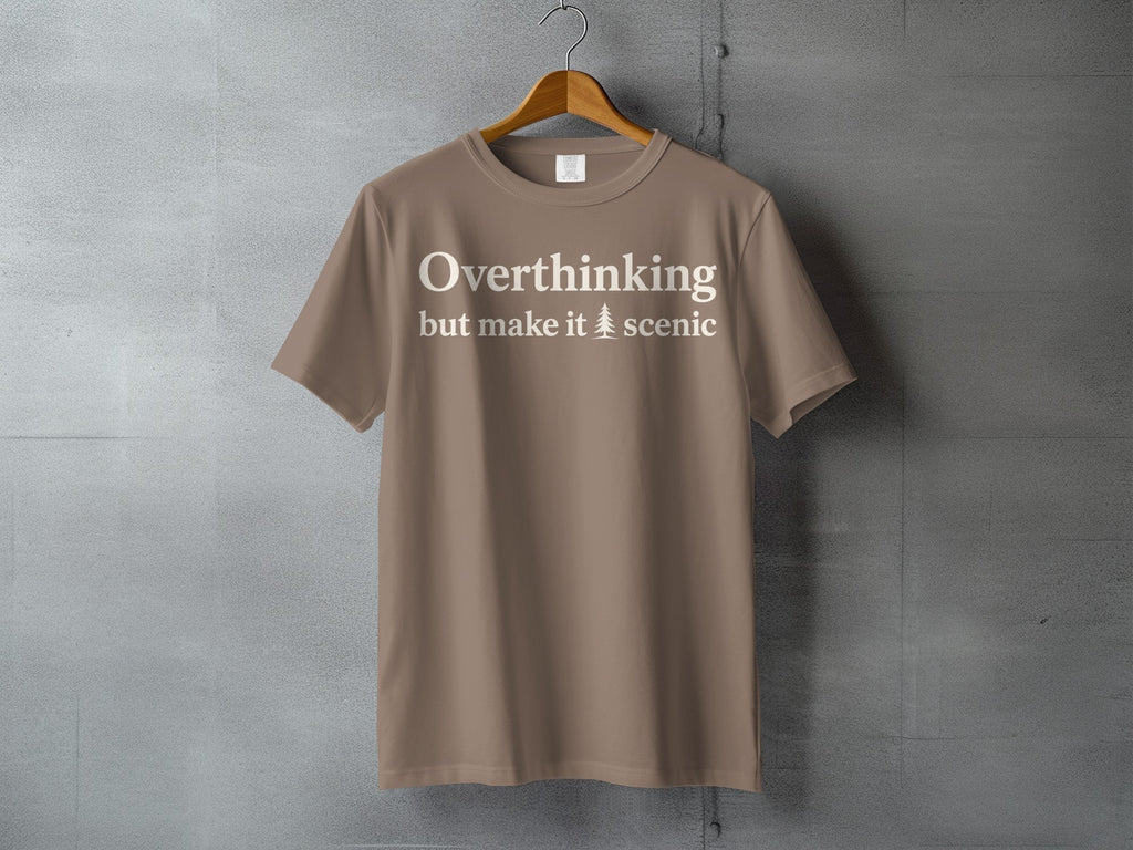 Taupe t-shirt with white text "Overthinking but make it 🌲 scenic"