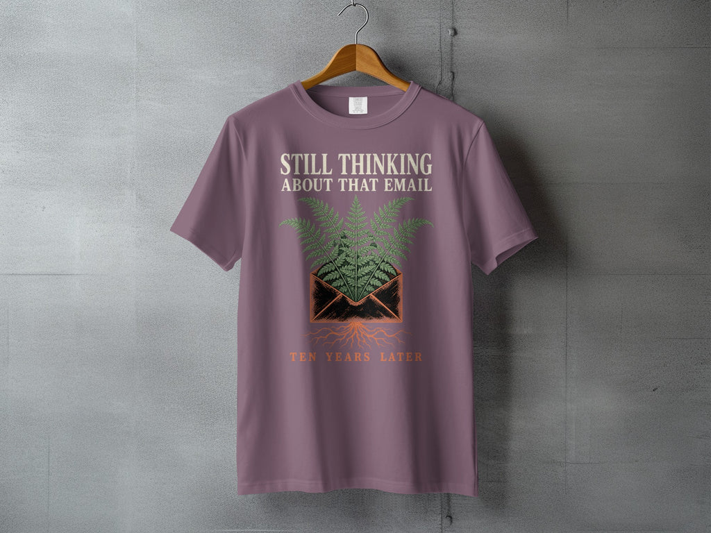 Mauve t-shirt with "STILL THINKING ABOUT THAT EMAIL TEN YEARS LATER" text and fern graphic.