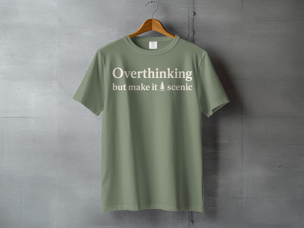 Olive t-shirt with "Overthinking but make it scenic" text and a tree graphic.