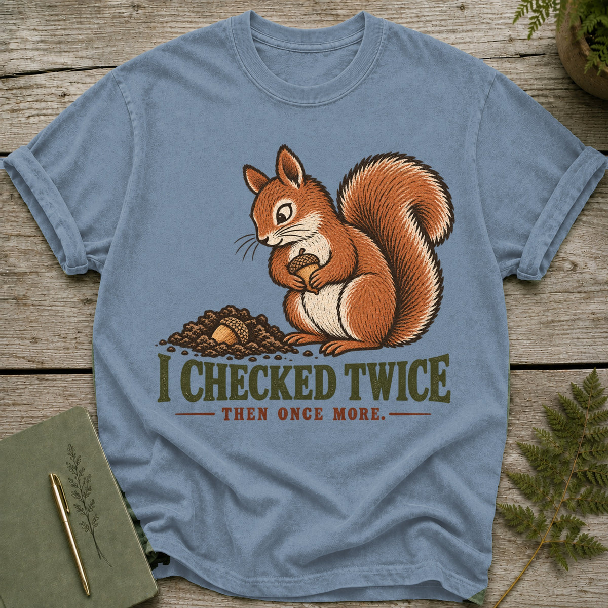 Blue t-shirt with a squirrel holding an acorn and the text "I CHECKED TWICE THEN ONCE MORE."
