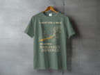 Green t-shirt with graphic of a person walking on a path, text reads "I WENT FOR A WALK RETURNED MARGINALLY IMPROVED".