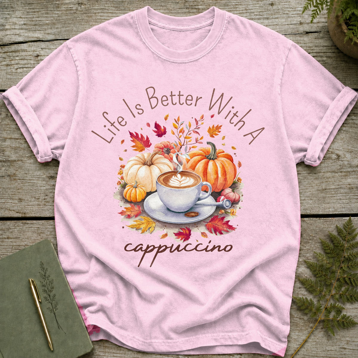 Pink t-shirt with "Life Is Better With A Cappuccino" and autumn pumpkins and leaves graphic.