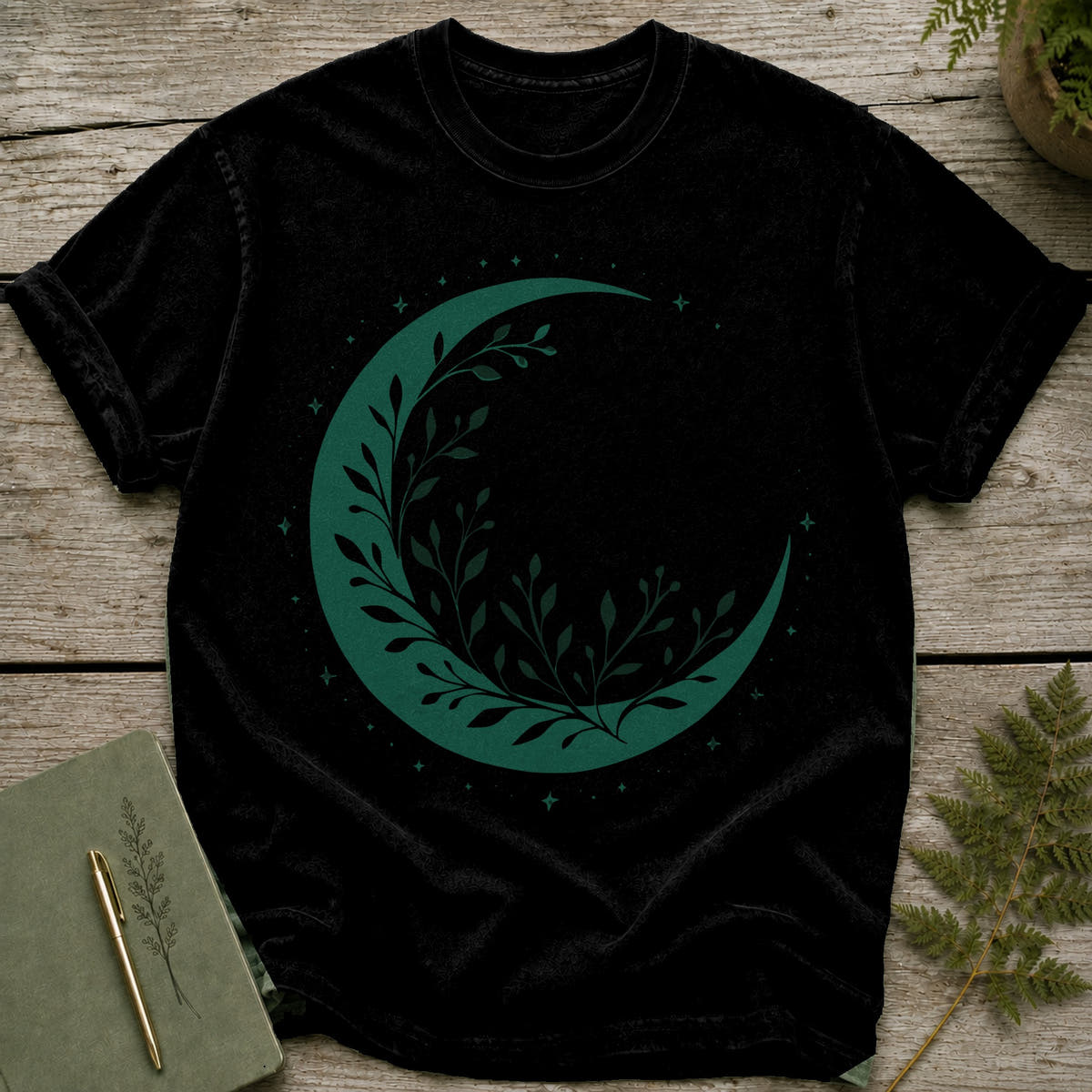 Black t-shirt with green crescent moon and leaf design