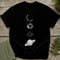 Black t-shirt with a vertical line of celestial illustrations: moon, sun, star, and Saturn.