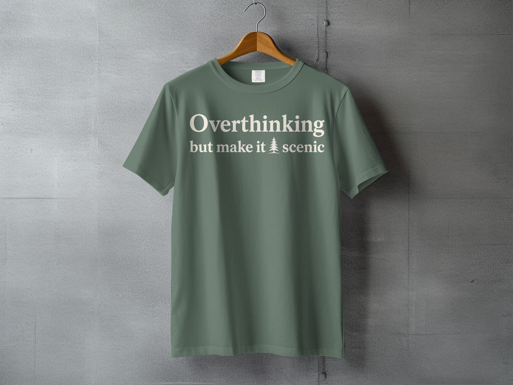 Green t-shirt with cream text "Overthinking but make it 🌲 scenic"