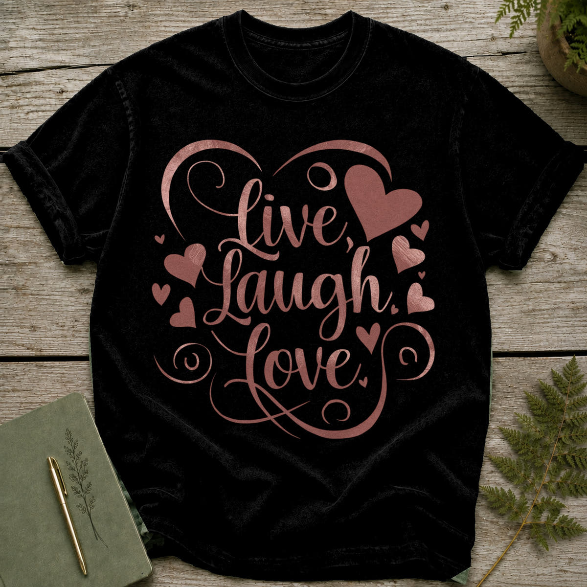 Black t-shirt with "Live, Laugh, Love" and heart graphic in rose gold.