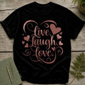 Black t-shirt with "Live, Laugh, Love" and heart graphic in rose gold.