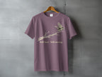 Mauve t-shirt with a bird on a branch graphic and text "Still here Still moving."