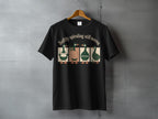 Black t-shirt with four stylized ducks and the text "Softly spiraling still moving."