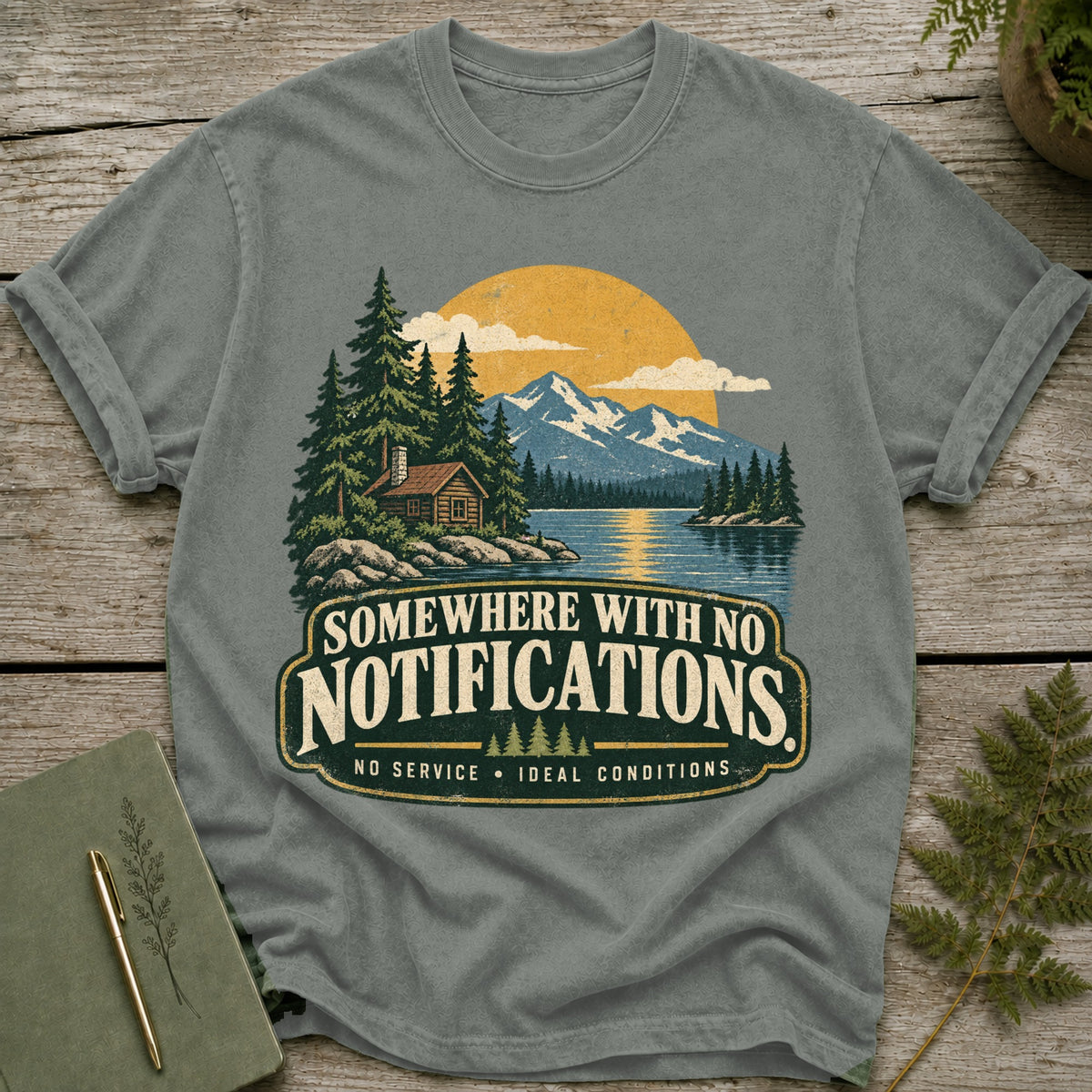 T-shirt with cabin, lake, mountains, and text "Somewhere with no notifications".