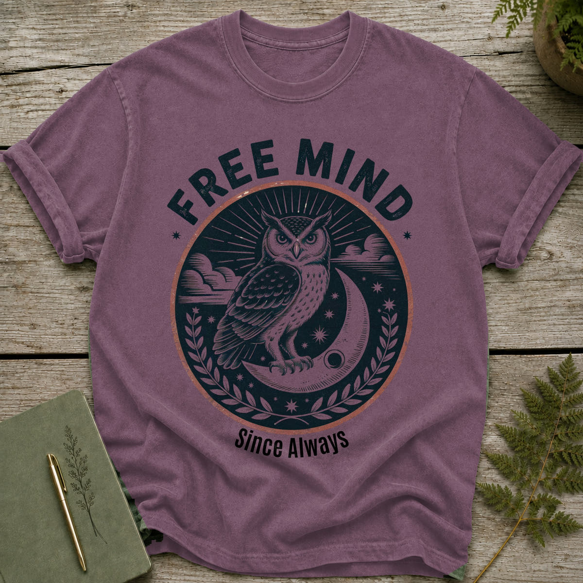 Purple t-shirt with an owl on a crescent moon graphic and "Free Mind Since Always" text.