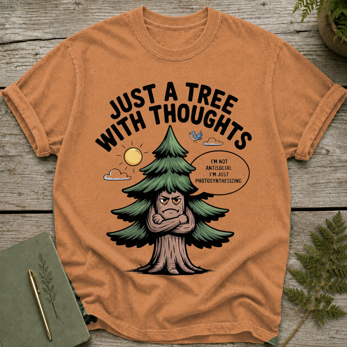 Orange t-shirt with a cartoon tree saying "I'm not antisocial, I'm just photosynthesizing."