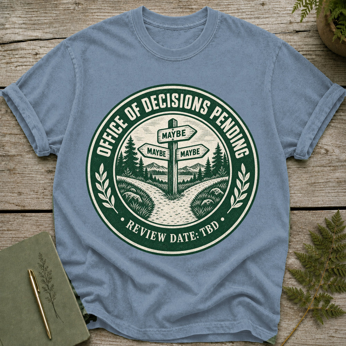 T-shirt graphic: "Office of Decisions Pending" with three "Maybe" signs and "Review Date: TBD".