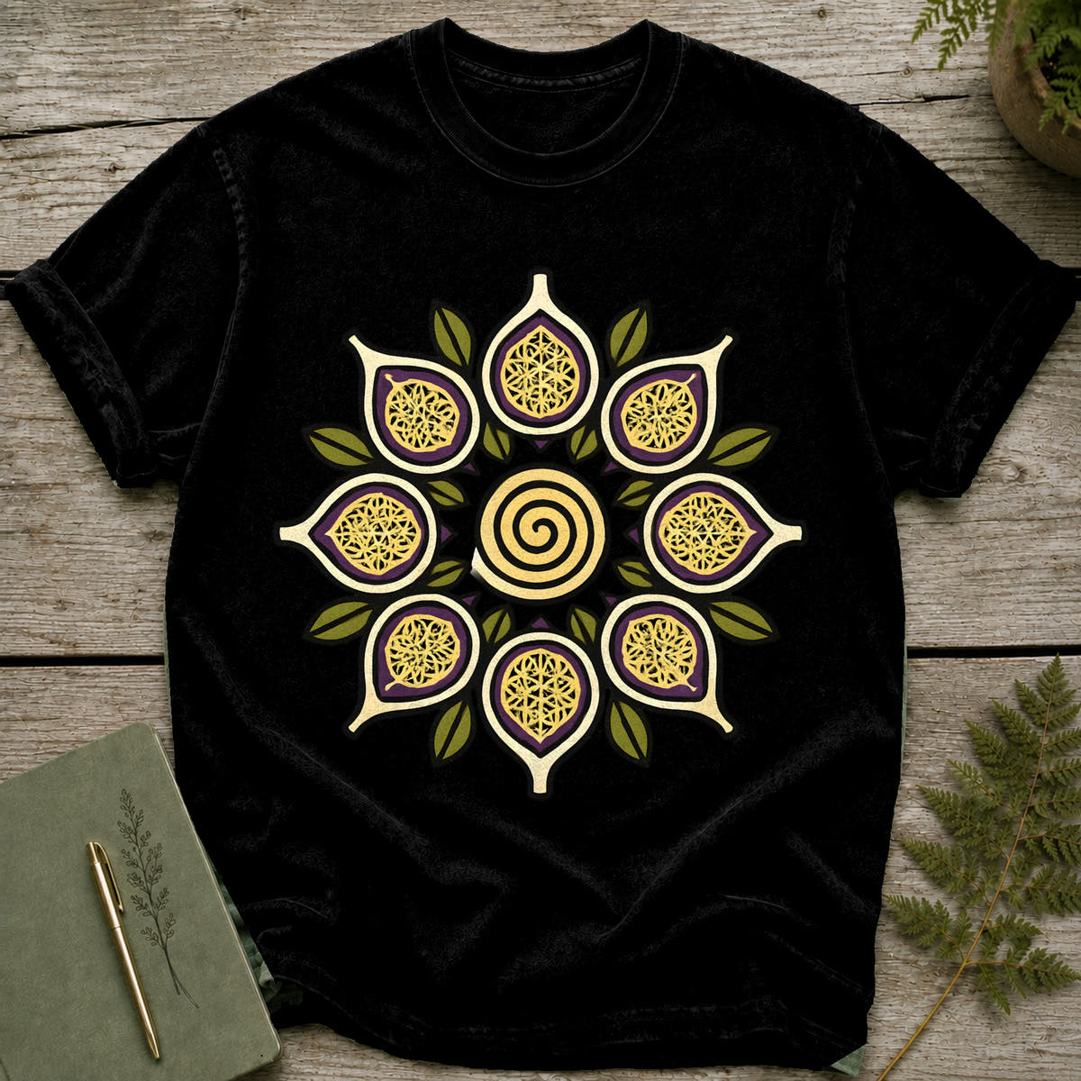 Black t-shirt with a circular mandala design featuring fig-like shapes and a spiral.