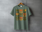 Sage Green Retro Floral Design Graphic T-shirt product type
sage green shirt
floral print
retro design
vintage inspired
botanical pattern
mid century modern
abstract flowers
graphic tee
nature motif
earth tones
t-shirt
apparel
clothing
unique design
orange flowers
green leaves
spring summer
boho style
aesthetic top
casual wear