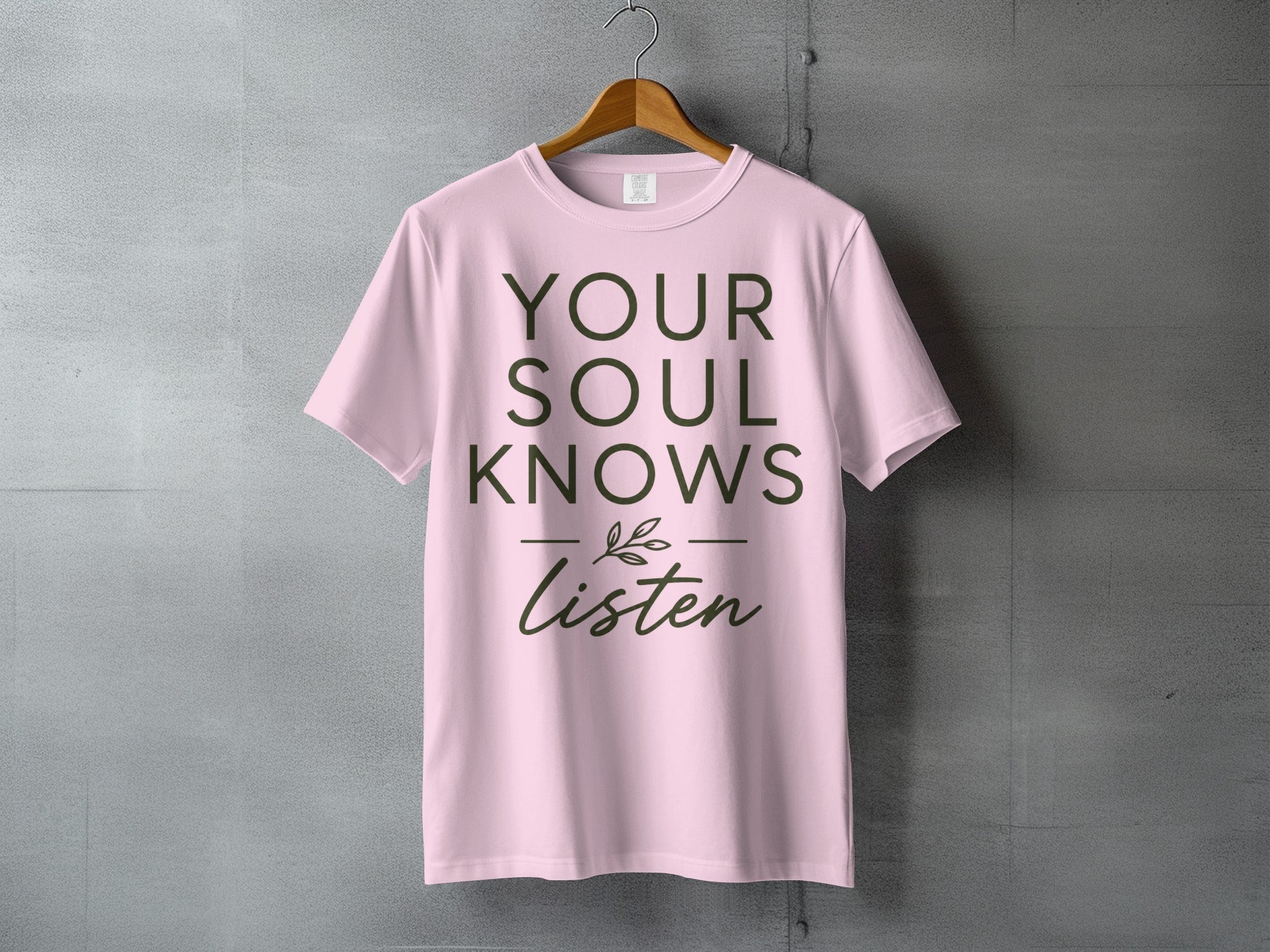 Pink t-shirt with "YOUR SOUL KNOWS Listen" text and a small leaf illustration.