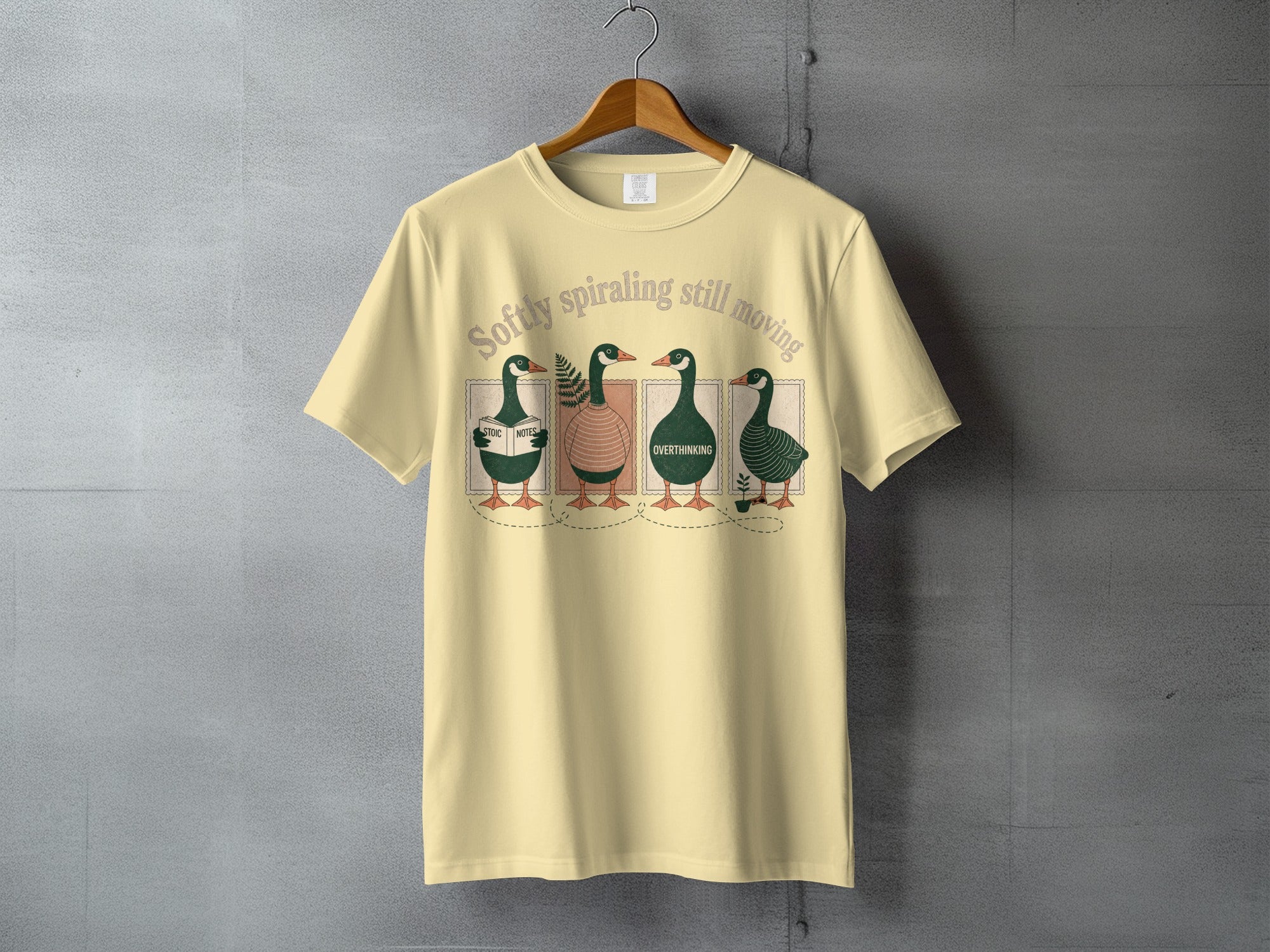 T-shirt with four ducks and text "Softly spiraling still moving".