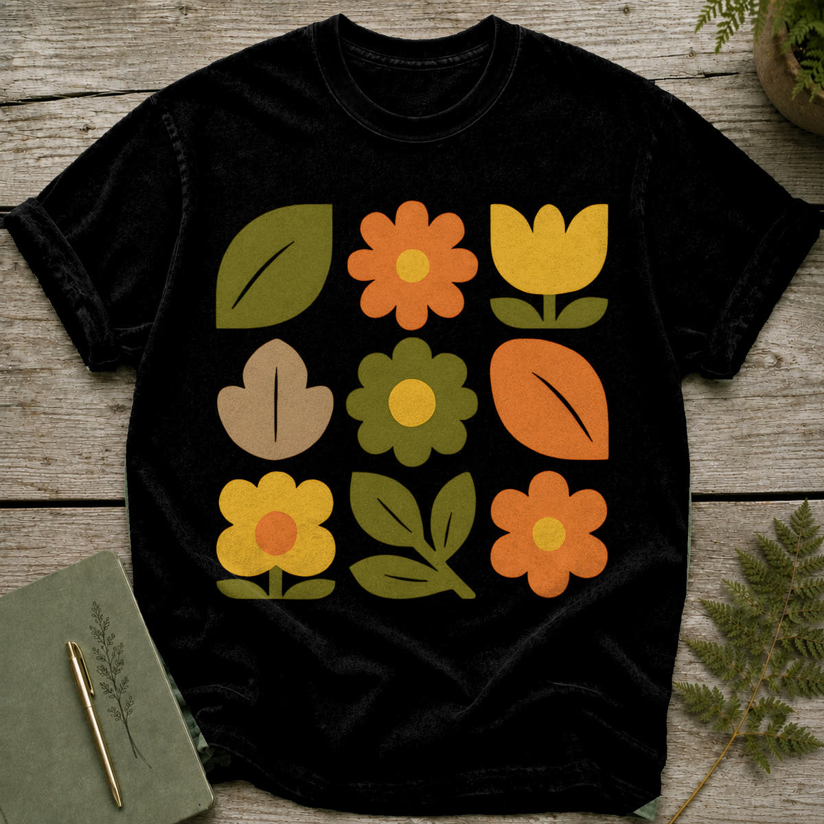 Black t-shirt with a 3x3 grid of colorful retro flowers and leaves.