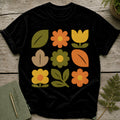 Black t-shirt with a 3x3 grid of colorful retro flowers and leaves.
