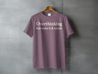 Dusty rose t-shirt with "Overthinking but make it scenic" text and a tree graphic.