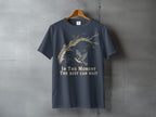 Dark blue t-shirt with a tree branch, bird, and the text "In The Moment The Rest Can Wait".