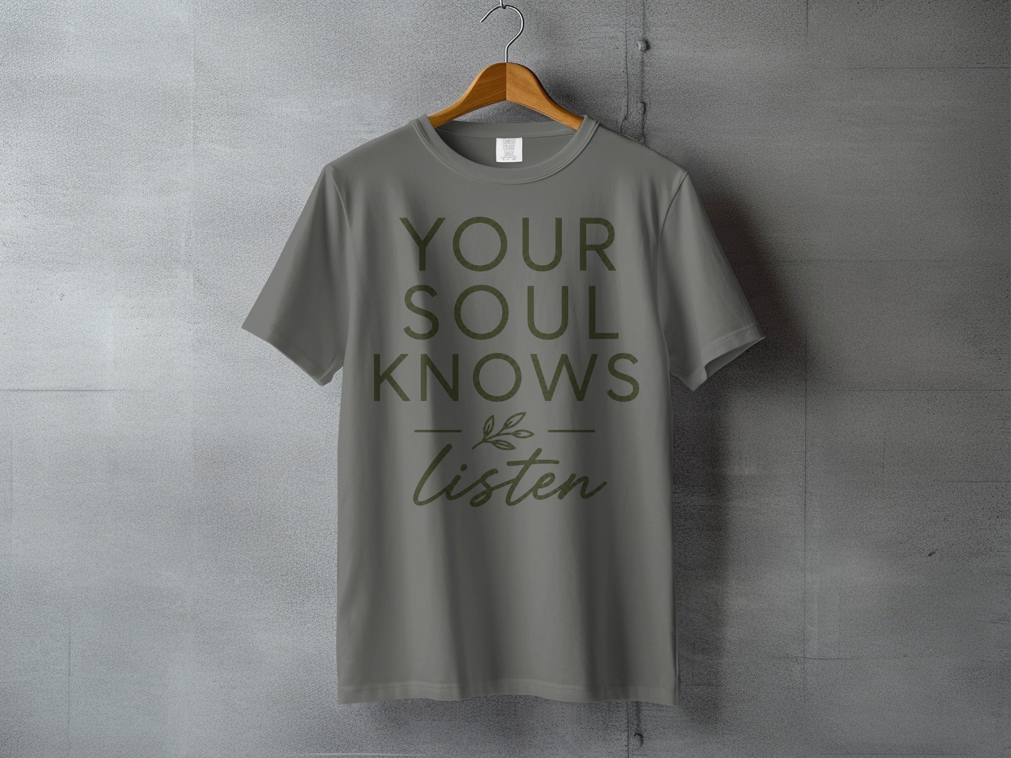 Gray t-shirt with "YOUR SOUL KNOWS Listen" text and decorative leaf.