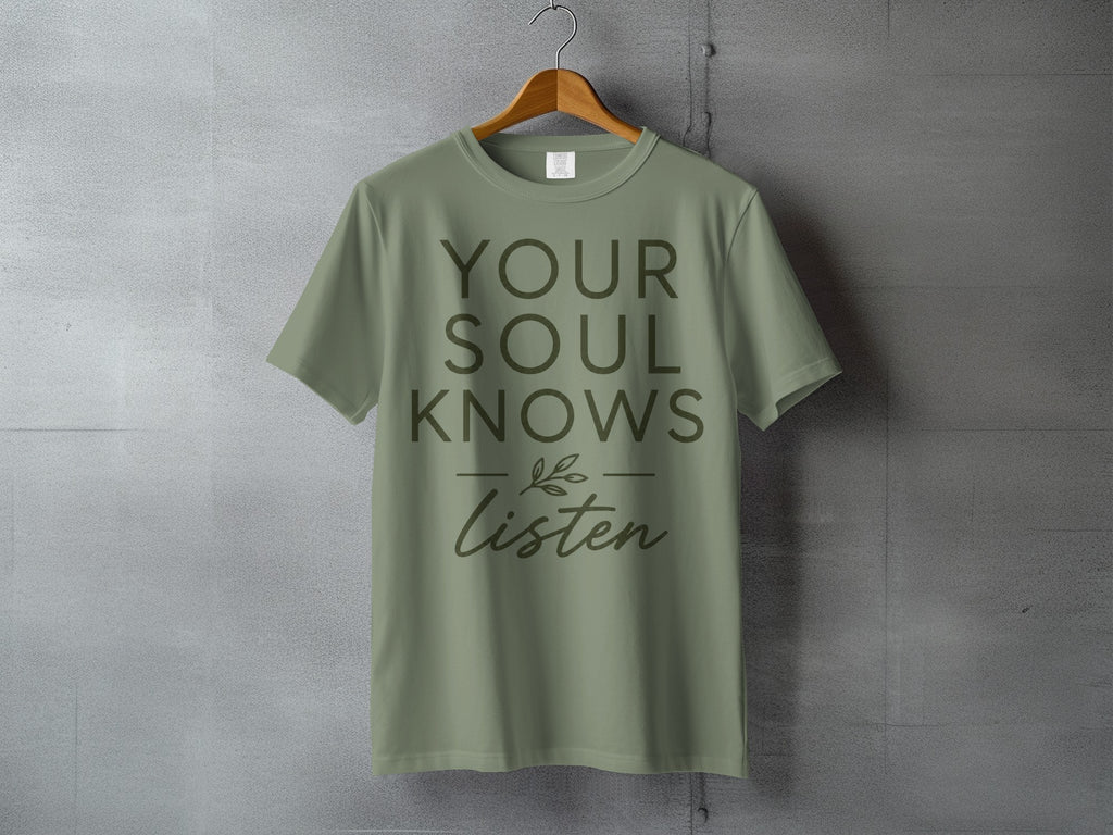 Olive green t-shirt with "YOUR SOUL KNOWS Listen" text and a leafy sprig design.