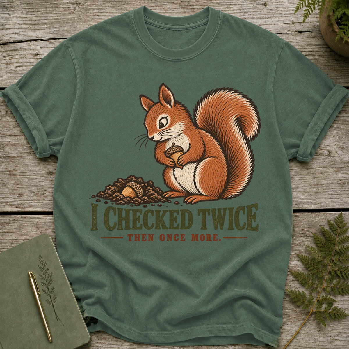 Green t-shirt with a squirrel holding an acorn and text "I CHECKED TWICE THEN ONCE MORE."