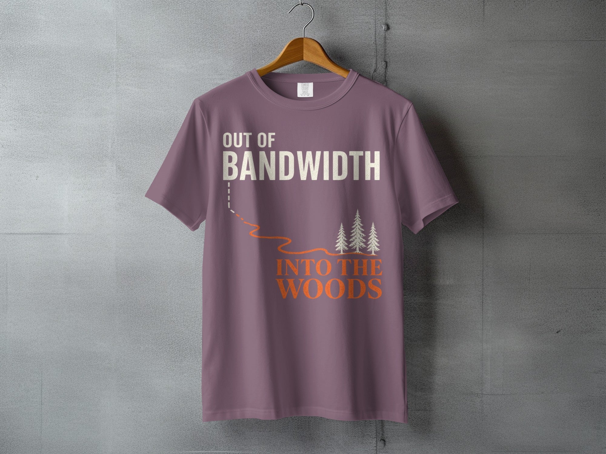 T-shirt with "Out of Bandwidth Into The Woods" text and forest graphic.