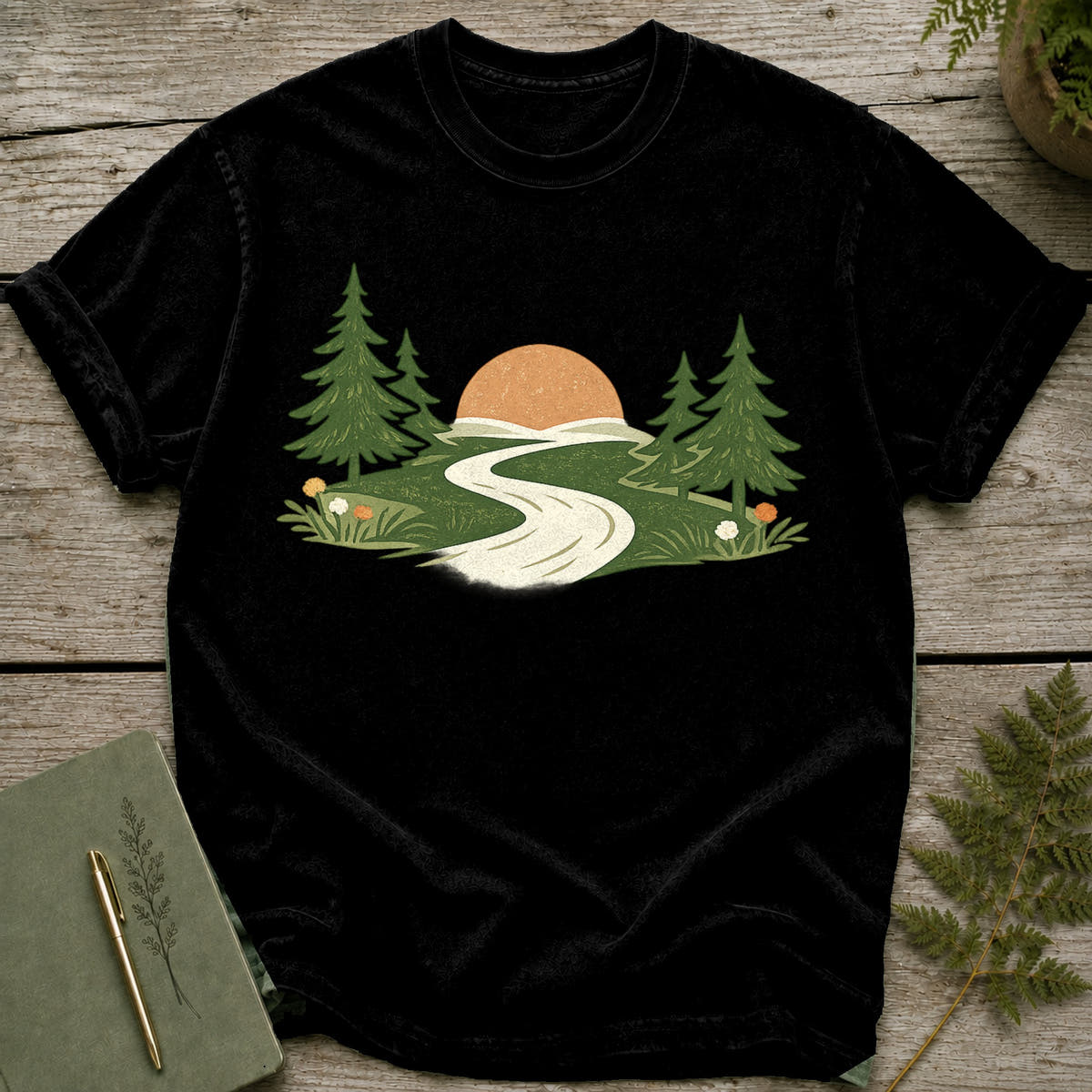 Black t-shirt with a forest scene: sunrise, trees, and a winding road.