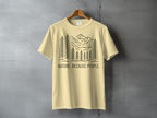 Yellow t-shirt with a black line drawing of mountains and trees, text reads "NATURE. BECAUSE PEOPLE."