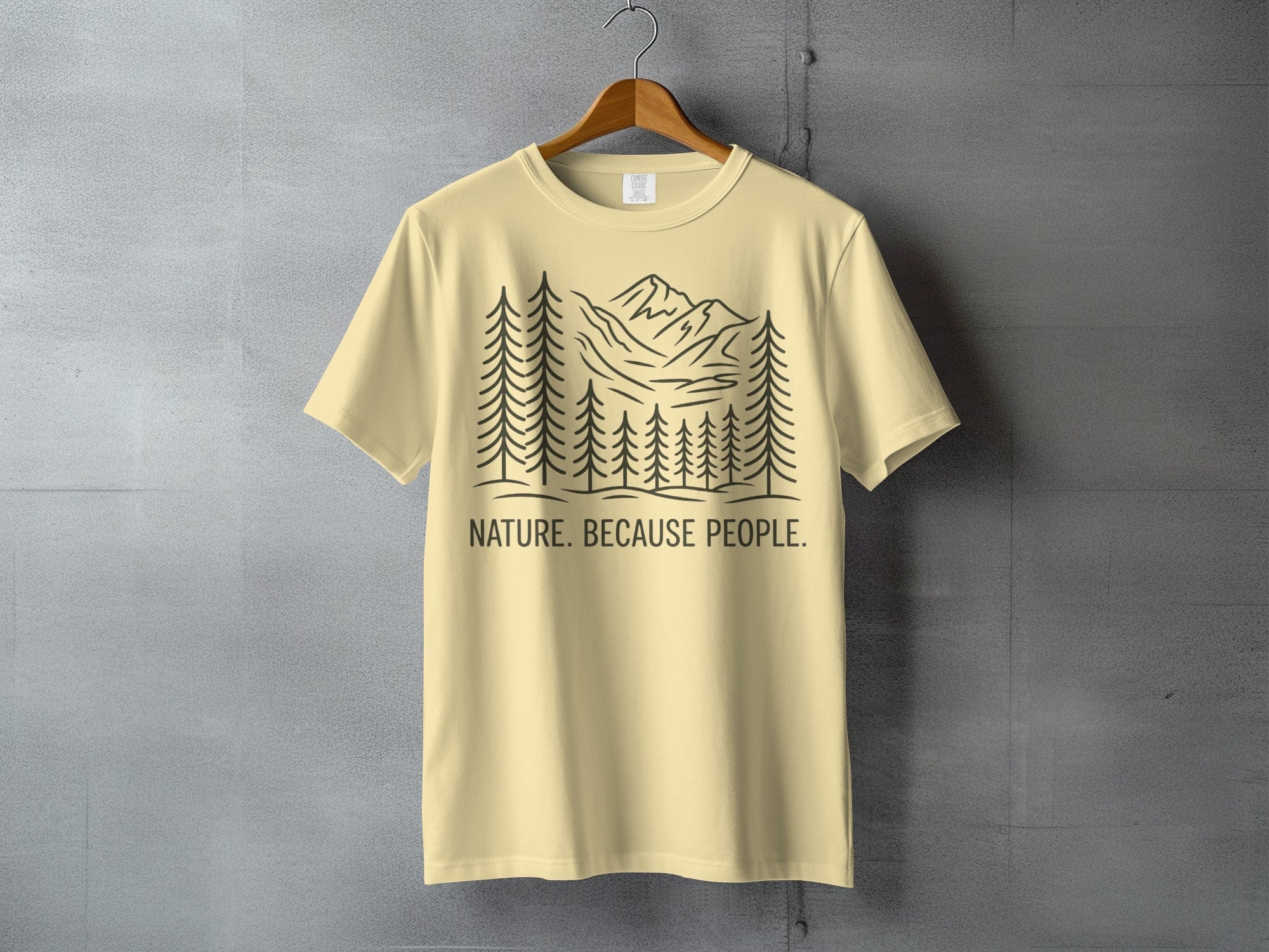 Yellow t-shirt with a black line drawing of mountains and trees, text reads "NATURE. BECAUSE PEOPLE."