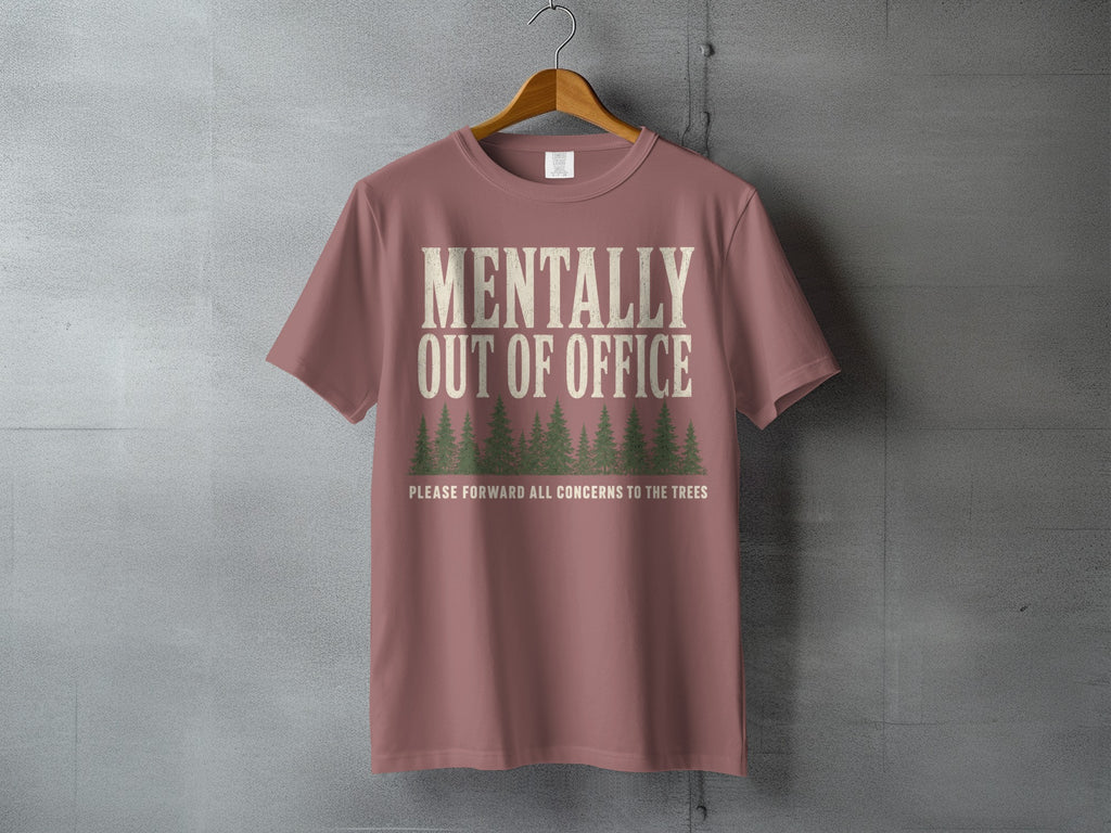 Dusty rose t-shirt with "Mentally Out of Office" and pine trees graphic.