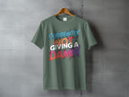 CURRENTLY NOT GIVING A DAMN Funny Saying product type
T-shirt
Funny shirt
Sarcastic shirt
Graphic tee
Statement tee
Casual wear
Humor shirt
Trendy apparel
Unique design
Expressive top
Novelty shirt
Quote shirt
Bold text
Green shirt
Colorful print
Short sleeve
Crew neck
Gift idea
Modern style
Everyday top